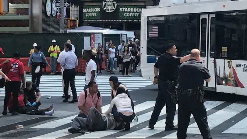 First responders at the scene as people help injured pedestrians after a vehicle struck pedestrians on a sidewalk in Times Square in New York, US. Photograph: Jeremy Schultz/Reuters