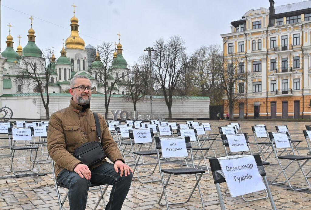 Nariman Dzhelyal and rows of chairs displaying the names of people who are missing or imprisoned in Russia, during a protest in Kyiv in November. Photograph: Sergei Supinsky/AFP via Getty