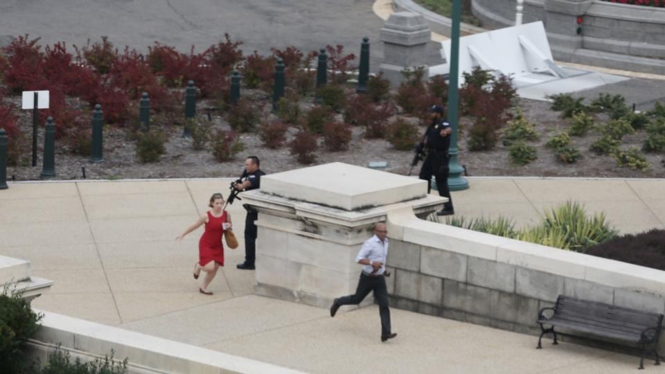 Police close in on the US Capitol as people run for cover after reports of a shooting. The US Capitol and the White House were placed on lockdown. Photograph: Alex Wong/Getty Images