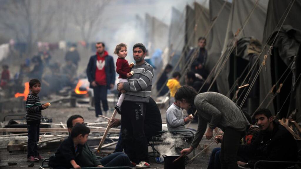 Camp life: a Syrian refugee holds a young girl at Harmanli refugee centre, in Bulgaria. Photograph: Nikolay Doychinov/AFP/Getty Images