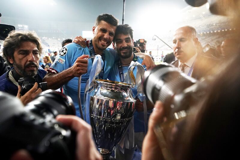 Manchester City's Ruben Dias (left) and Ilkay Gundogan with the UEFA Champions League Trophy following victory over Inter Milan in the Champions League final at the Ataturk Olympic Stadium, Istanbul. Photograph: Martin Rickett/PA Wire
