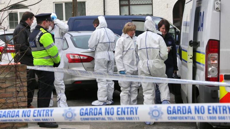 Gardaí at the scene where the body of a man in his 40s was found in a house in Cabra. Photograph: Collins Dublin.