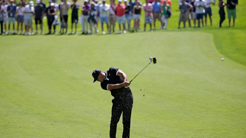 Koepka hits his approach to the second. Photo: Seth Wenig/AP Photo