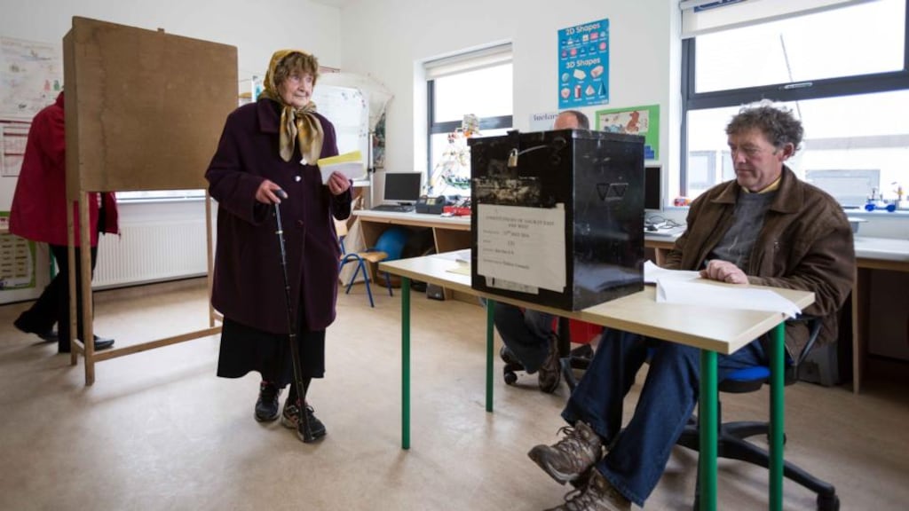 BrÍd NÍ Greofa (88) voting in Inis Oírr national school with Pádraic Ó Conghaile, presiding officer, and Pádraig Ó Donncha, poll clerk, in attendance. Photograph: Eamon Ward