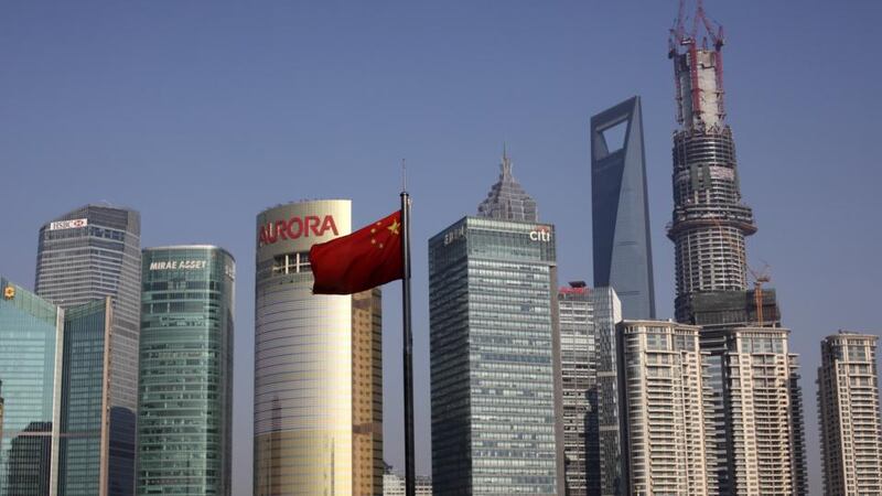 China’s national flag flies in front of commercial buildings Shanghai’s financial district. The skyscraper in China has come to occupy a similar position to its status Chicago at the turn of the 20th century, a symbol of unstoppable progress, of rising wealth. Photograph: Tomohiro Ohsumi/Bloomberg via Getty Images