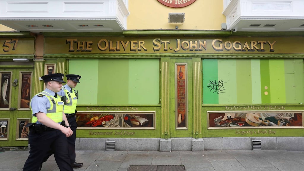 Gardaí passing a closed pub in Temple Bar, Dublin. File photograph: Leah Farrell/Rollingnews.ie