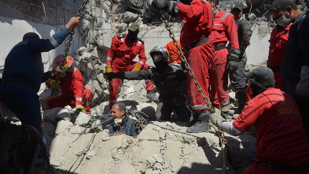 Firefighters look for bodies  of civilians who were killed in an air strike against Islamic State by US-led coalition forces. Photograph: Reuters