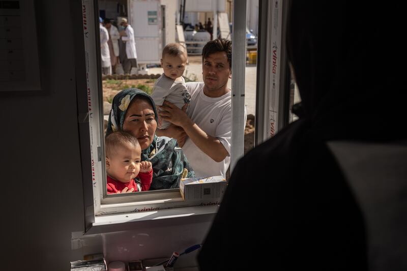 A mother and child get medicine from a United Nations-run pharmacy at a reception centre for refugees returning from Iran. Photograph: Jim Huylebroek/The New York Times