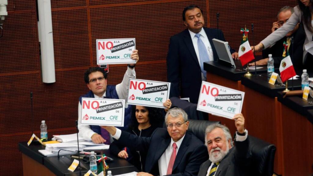 Senators  of the Party of the Democratic Revolution (PRD) hold up placards reading: “No to the privatization of Pemex” before a debate on an energy reform bill at the Senate in Mexico City last month. Photograph: Reuters