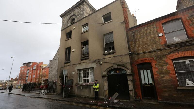 Gardai investigate a fire at apartments on Thomas Court in Dublin where three adults and five children where rescued. Photograph: Arthur Carron/Collins