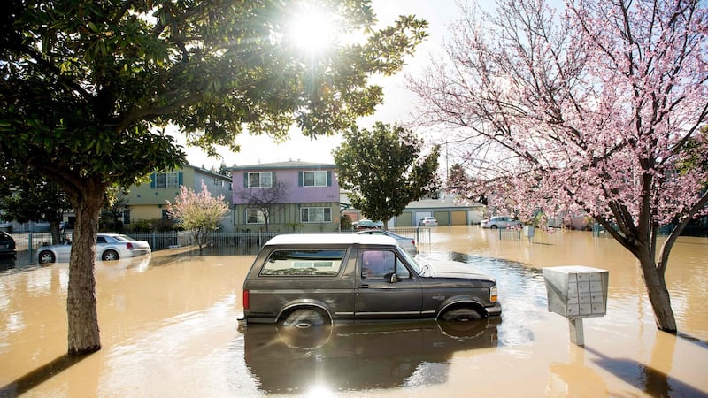 A Ford Bronco rests in floodwaters in February 2017, in the Rock Springs area of San Jose, California. The IPCC report says climate change is bringing more intense rainfall and associated flooding. Photograph: Getty Images