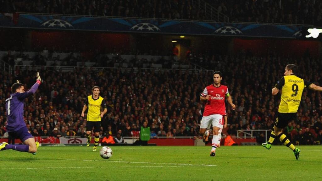 Robert Lewandowski of Borussia Dortmund scores the winner past Wojciech Szczesny of Arsenal. Photograph: Mike Hewitt/Bongarts/Getty Images