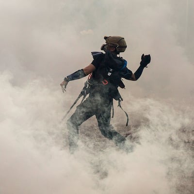 Hong Kong: a protester throws a brick. Photograph: Isaac Lawrence/AFP/Getty