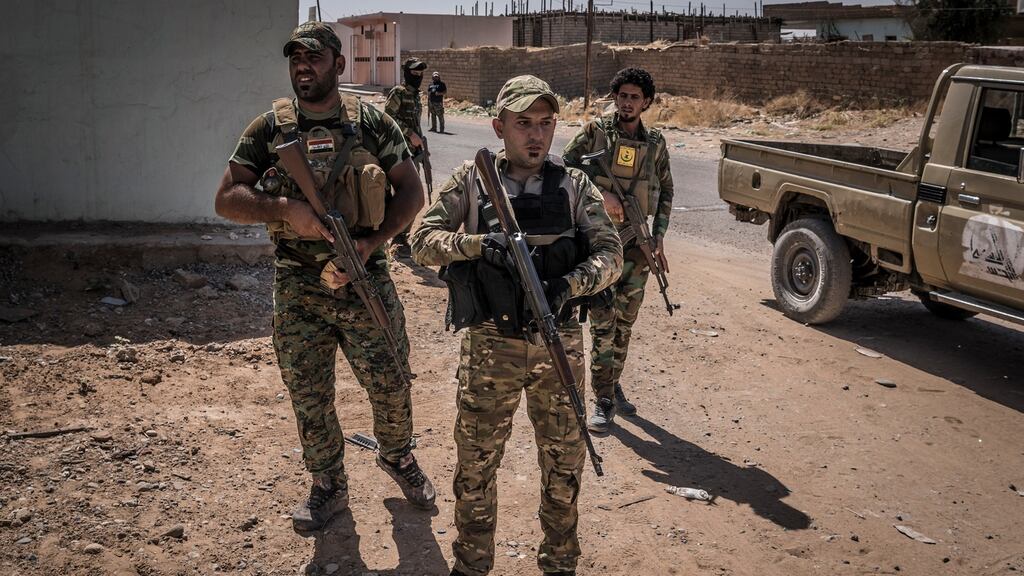 Shi’ite militiamen in al-Mazraa, Iraq. While Iran has built up militias to fight Islamic State in Iraq, it has also mobilised an army of Shi’ite Iraqi men to fight on its behalf in Syria. Photograph: Sergey Ponomarev/New York Times