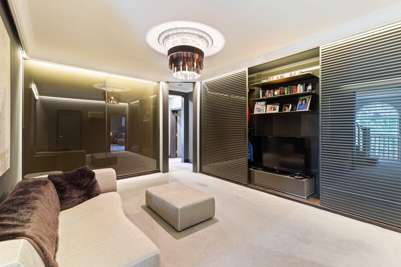 Livingroom for principal bedroom where utility services hide behind sliding doors