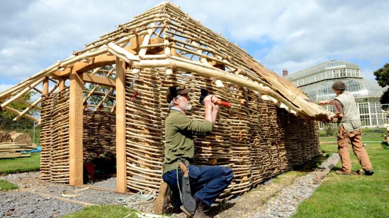 Master craftsman Eoin Donnelly (left), Enniscorthy, and thatcher Peter Compton from Cavan, working on a replica of a thousand-year-old Viking thatched house at the National Botanic Gardens, in 2014. The building remains in place. File photograph: Eric Luke/The Irish Times