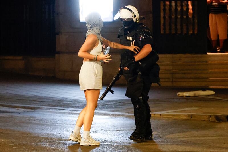 A riot police officer and an anti-government protester in Belgrade. Photograph: Marko Djokovic/Getty Images