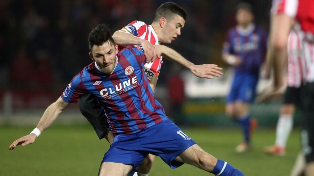 Killian Brennan of St Pats holds off the challenge of Derry City’s Michael Duffy at the Brandywell. Photograph: Lorcan Doherty/Inpho