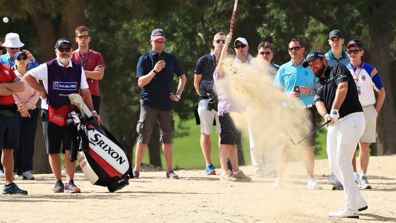 Lowry plays his second shot on the second hole. Photo: Andrew Redington/Getty Images