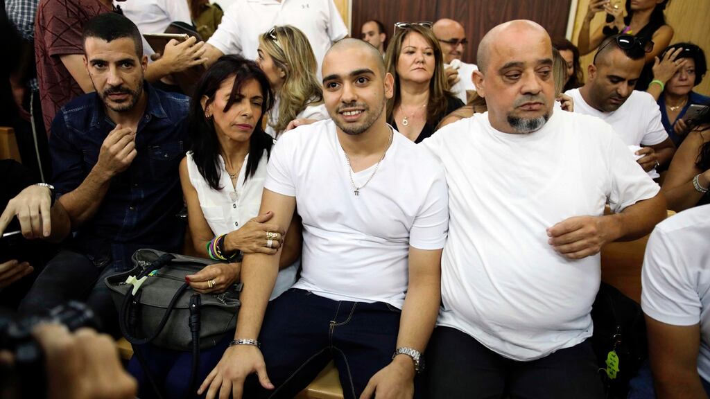 Convicted Israeli soldier Elor Azaria, centre, flanked by his parents inside an Israeli military court in Tel Aviv, Israel. Photograph: Dan Balilty/EPA