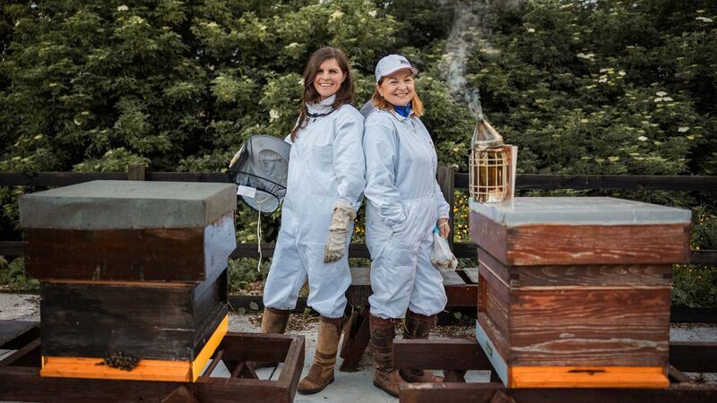 Sally Anne Cooney, left, with her mother Marie Cooney, with some of the beehives at the family’s lands in Kilmessan, Co Meath