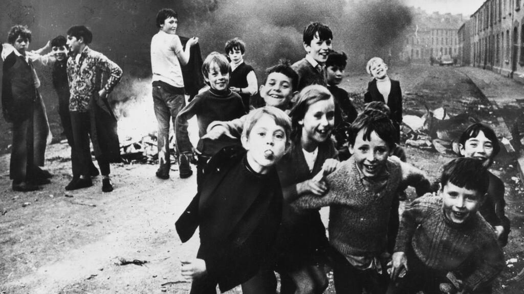 Children in Belfast jeer at British soldiers in December 1971 while a fire smoulders in the street behind them. Photograph: Keystone/Getty Images