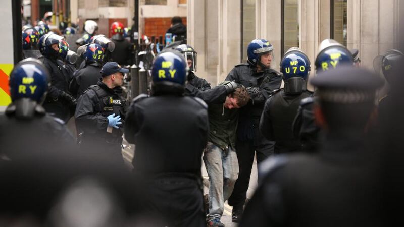 A man is detained by police on Golden Square, London during a protest ahead of next week’s G8 summit in Northern Ireland. Photograph: Oli Scarff/Getty Images