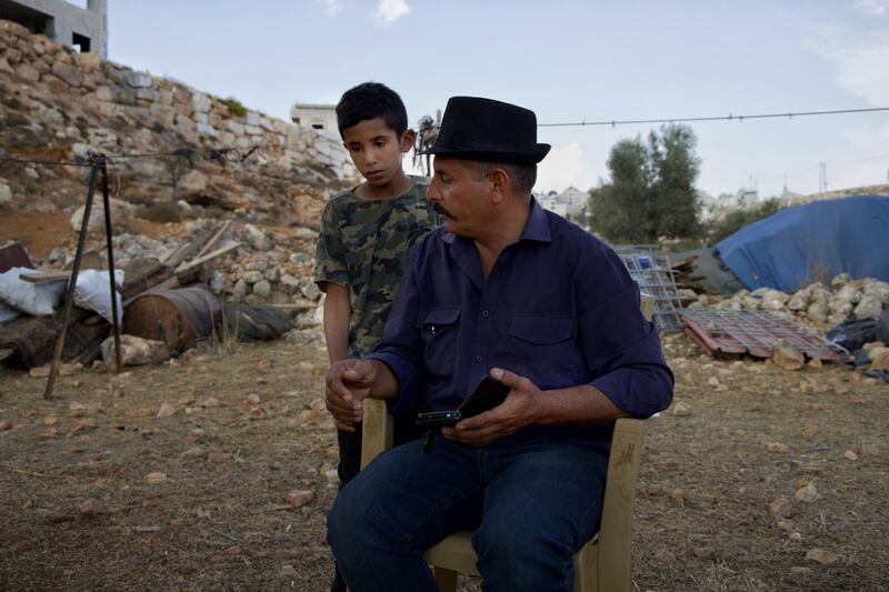 Abu Bashar, 48, a community leader for the Bedouins at Wadi a-Seeq, with his son in Taybeh where they are staying after being displaced. Photograph: Hannah McCarthy