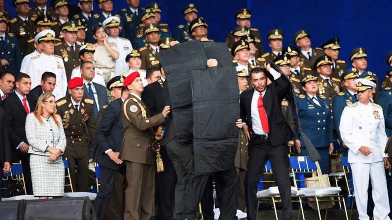 In this photo released by China’s Xinhua News Agency, security personnel with shielding surround Venezuela’s President Nicolas Maduro during an incident as he gave a speech in Caracas, Venezuela, on Saturday. Photograph: Xinhua/AP
