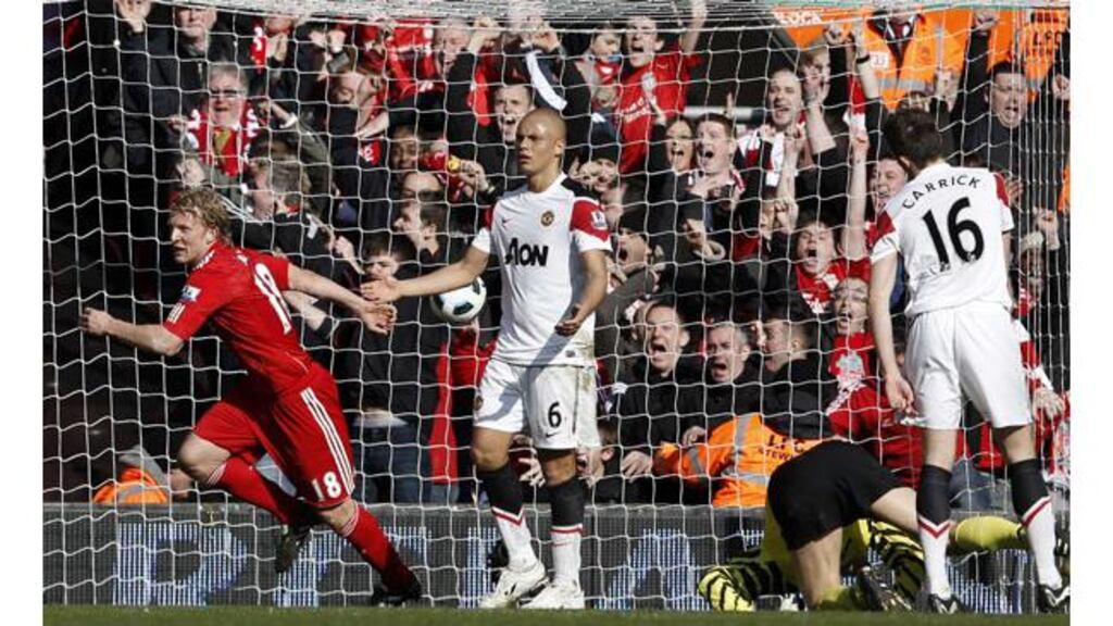 Liverpool's Dirk Kuyt (left) celebrates the second of his three goals against Manchester United at Anfield - (Photograph: Phil Noble/Reuters)