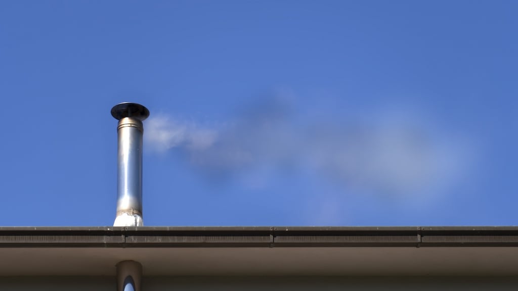 The flue rises above the single-storey extension roof but does not rise above the main house roof. Photograph: Getty Images/iStockphoto