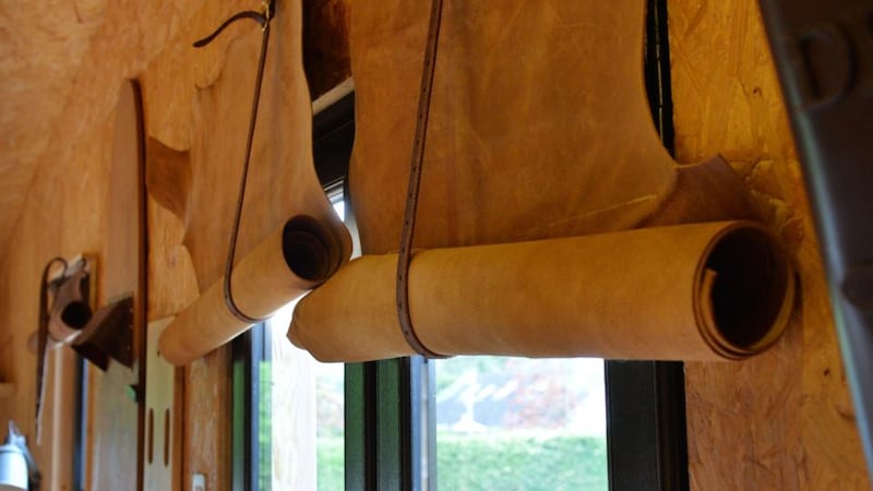 Leather “blinds” are held up with straps
