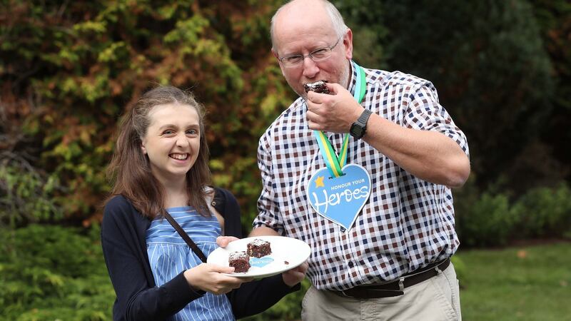 Katie Kennedy from Kildare honouring consultant neurosurgeon Mr John Caird with his award and some brownies. Photograph: Robbie Reynolds