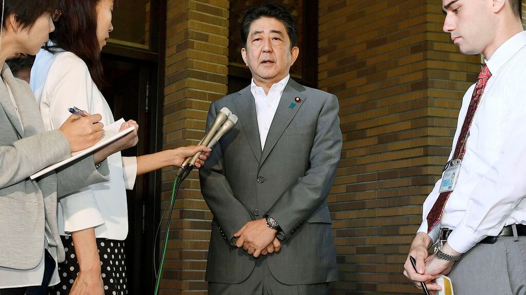 Japan’s prime minister Shinzo Abe speaks to reporters after having a telephone call with US resident Donald Trump at the prime minister’s former official residence in Tokyo, Japan. Photograph: Kyodo/Reuters