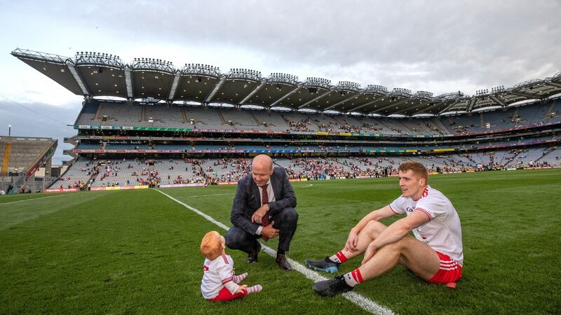 Tyrone’s Peter Harte with his father-in-law Peter Canavan and daughter Ava after the game. Photo: James Crombie/Inpho