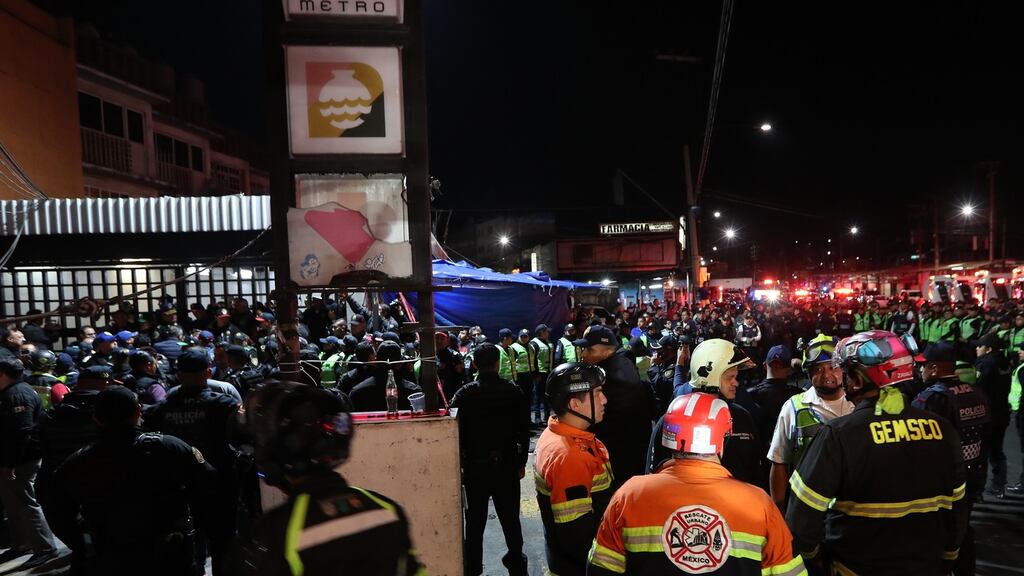Members of the emergency services are deployed outside a subway station after two trains collided in Mexico City, Mexico. Phopgraph: Mario Guzman / EPA