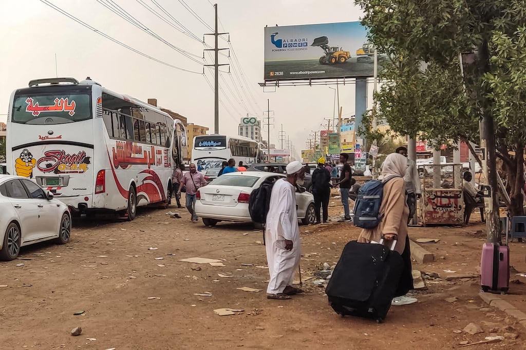 People prepare to board a bus departing from south Khartoum as battles rage in the city. Photograph: AFP via Getty Images