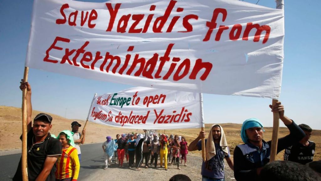 Displaced people from the minority Yazidi sect, who had fled violence in the Iraqi town of Sinjar, take part in a demonstration at the Iraqi-Syrian border crossing in Fishkhabour, Dohuk province, yesterday. Photograph: Youssef Boudlal/Reuters