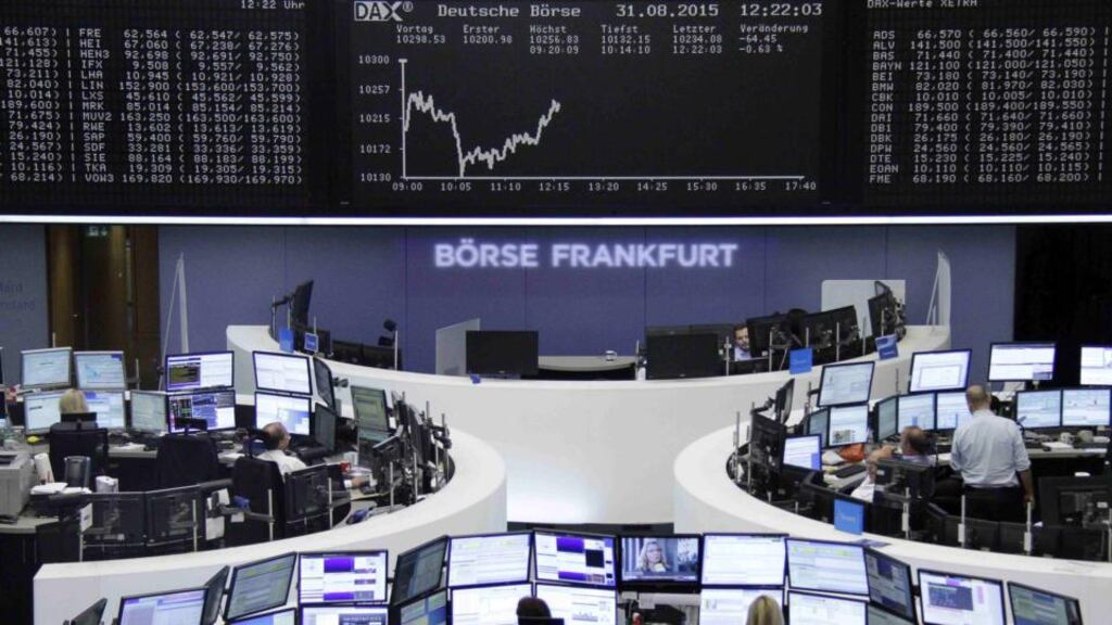 Traders at their desks in front of the DAX board at the Frankfurt stock exchange on Monday.  Photograph: Reuters