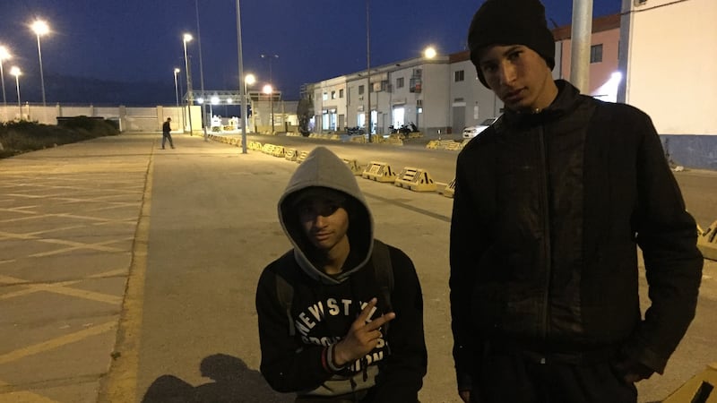 Mohamed (left) and Ayman in Ceuta’s port area where each day they attempt to stow away on vehicles heading for the Spanish mainland. Photograph: Guy Hedgecoe