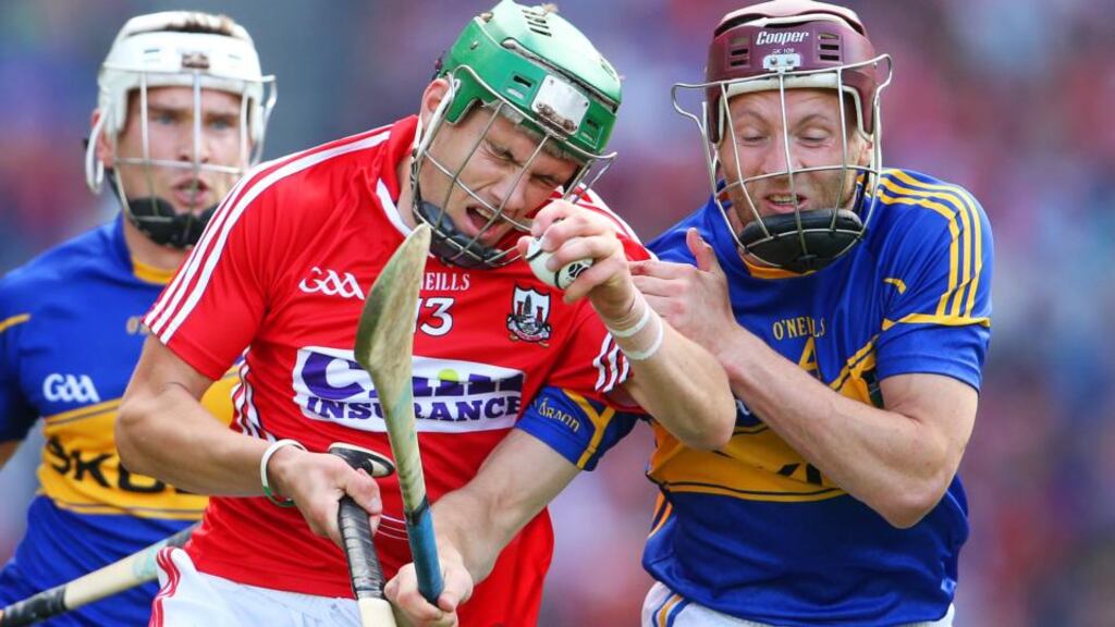 Cork’s Alan Cadogan and Paddy Stapleton of Tipperary clash in yesterday’s All-Ireland hurling semi-final. Photograph: Cathal Noonan/Inpho