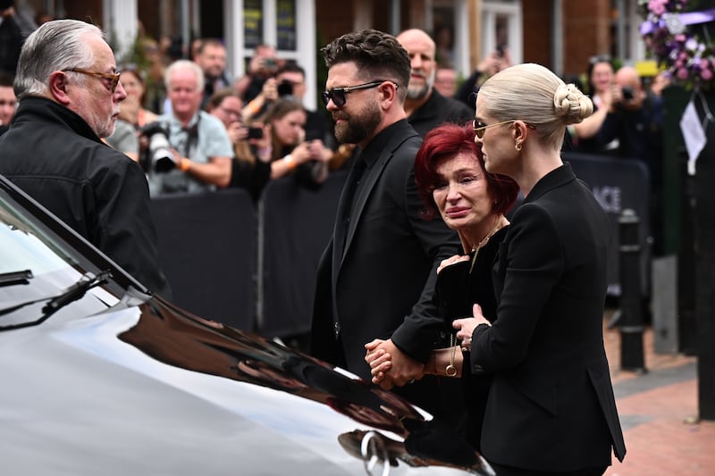 Jack Osbourne, Sharon Osbourne and Kelly Osbourne view tributes from fans. Photograph: Leon Neal/Getty Images