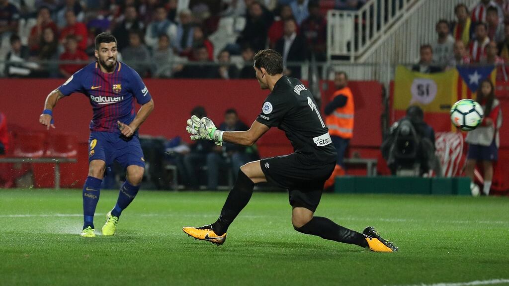 Luis Suarez scores Barcelona’s third goal against Girona in the 3-0 victory at the Estadi Montilivi. Photograph: Albert Gea/Reuters