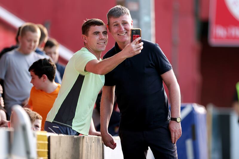 St Patrick's Athletic manager Stephen Kenny poses for a photo with a fan before Monday night's game with Shelbourne. Photograph: Laszlo Geczo/Inpho.