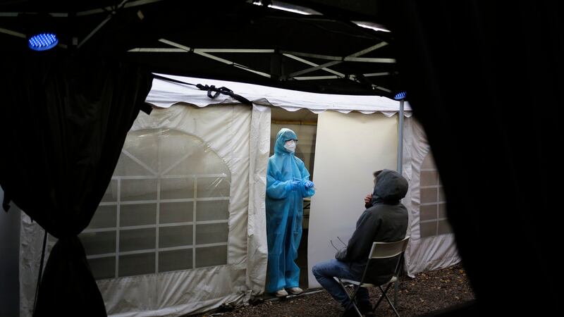 A medical staff explains a SARS CoV-2 rapid test to a person at the Corona Antigen Rapid test center at the ‘KitKat-Club’ in Berlin, Germany. Photograph: Markus Schreiber