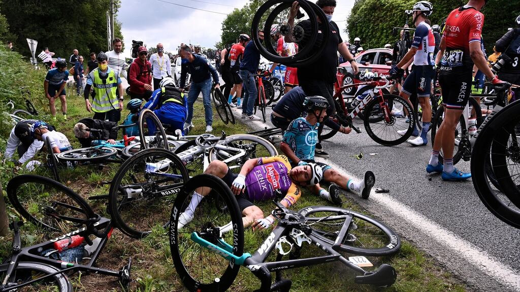 Riders on the ground after a mass crash during the 1st stage of the Tour de France. Photo: Anne-Christine Poujoulat/EPA