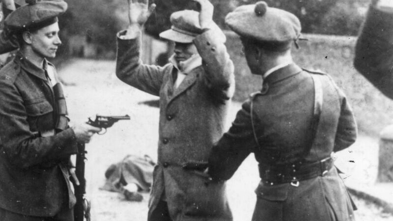 Members of the Black and Tans search an Irish civilian suspect. Photograph:  Topical Press Agency/Getty Images