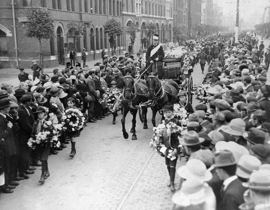 A funeral procession for a victim of the Irish Civil War makes its way along a street crowded with mourners in 1922. Photograph: by Sean Sexton/Getty Images