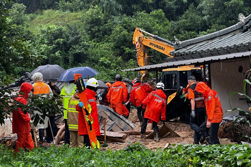 Rescue workers search the wreckage of a house in Yeongju. Photograph: Gyeongbuk fire station service headquarters/Yonhap/AP