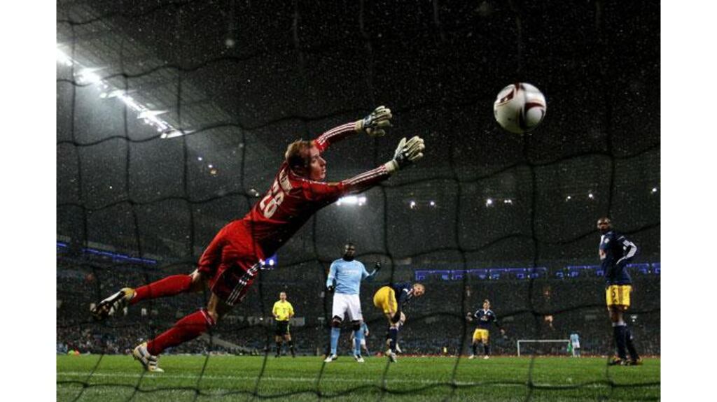 Gerhard Tremmel of FC Salzburg is unable to stop Mario Balotelli of Manchester City scoring the opening goal during their Uefa Europa League Group A match at Eastlands, Manchester. (Photograph: Alex Livesey/Getty Images)